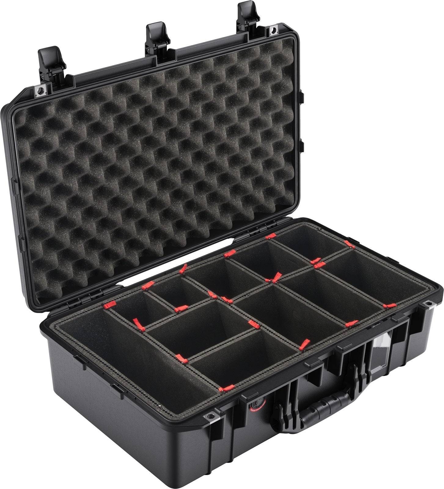 The 1555 Air Case is a hard plastic PELI carrying case with a foam-lined lid and adjustable padded compartments. It is open, displaying its dividers and interior storage sections, offering premium waterproof protection.