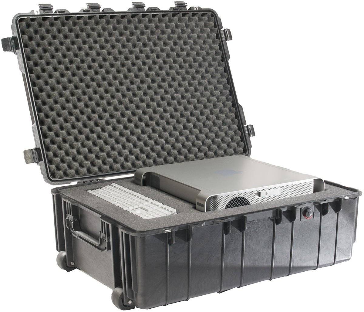 A black 1730 Protector Transport Case, a durable hard-shell rolling and watertight case with foam padding, securely holds a desktop computer tower and keyboard. The open protective case is displayed on a white background.