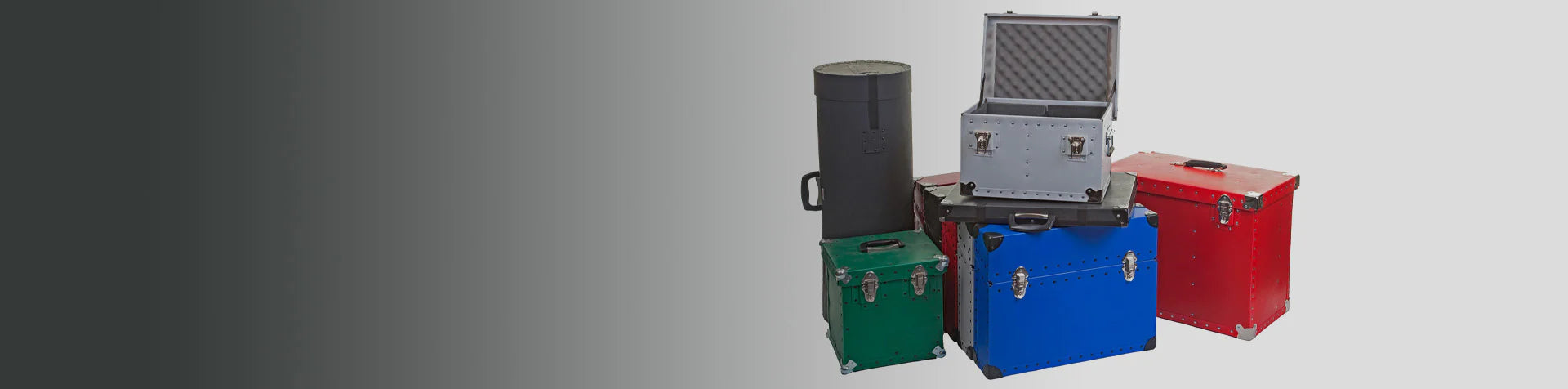 A group of colored metal storage cases, including red, blue, green, and black, with one silver case open to reveal foam padding inside, arranged on a neutral background.