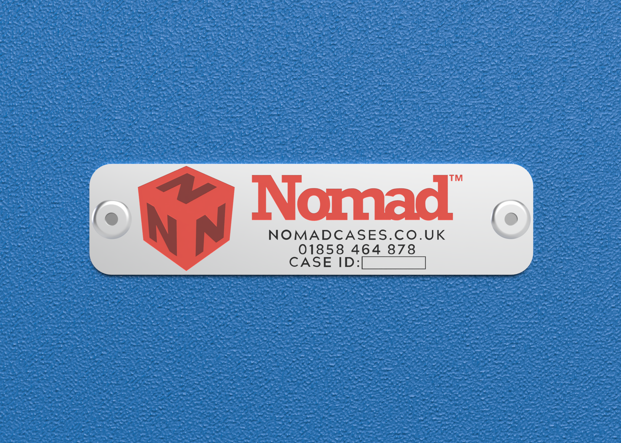 A white metal label with the Nomad logo, website, phone number, and a blank field for case ID, attached to a textured blue surface with two screws.