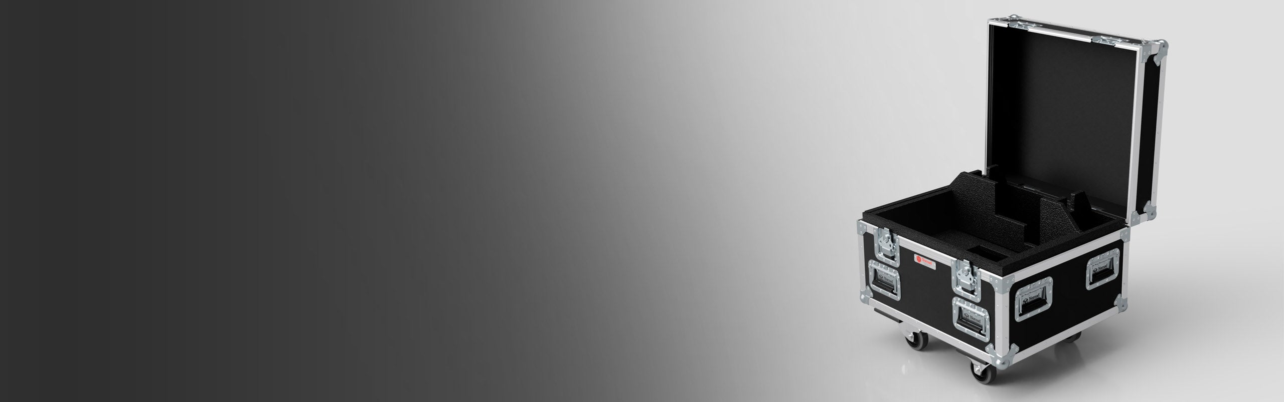 A black, wheeled flight case with metal reinforcements and an open lid sits on a gradient grey background.