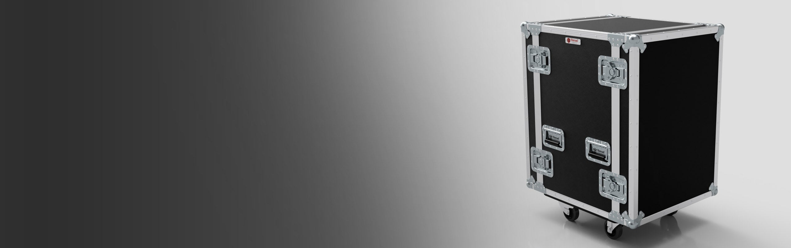 A large black and silver equipment flight case with metal edges and corners, secure latches, and wheels sits on a gradient gray background.