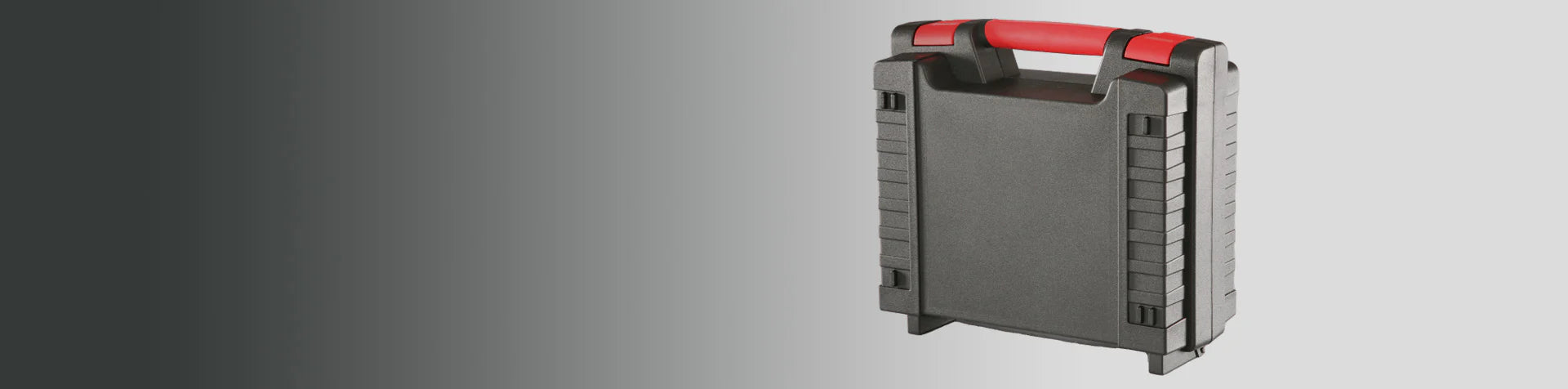 A black plastic carrying case with a red handle stands upright against a gradient gray background.