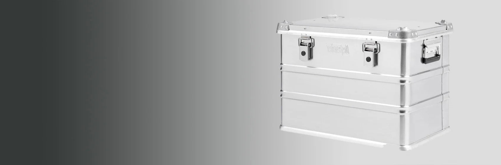 A large, silver metal storage case with latches and side handles is positioned against a gradient grey background.