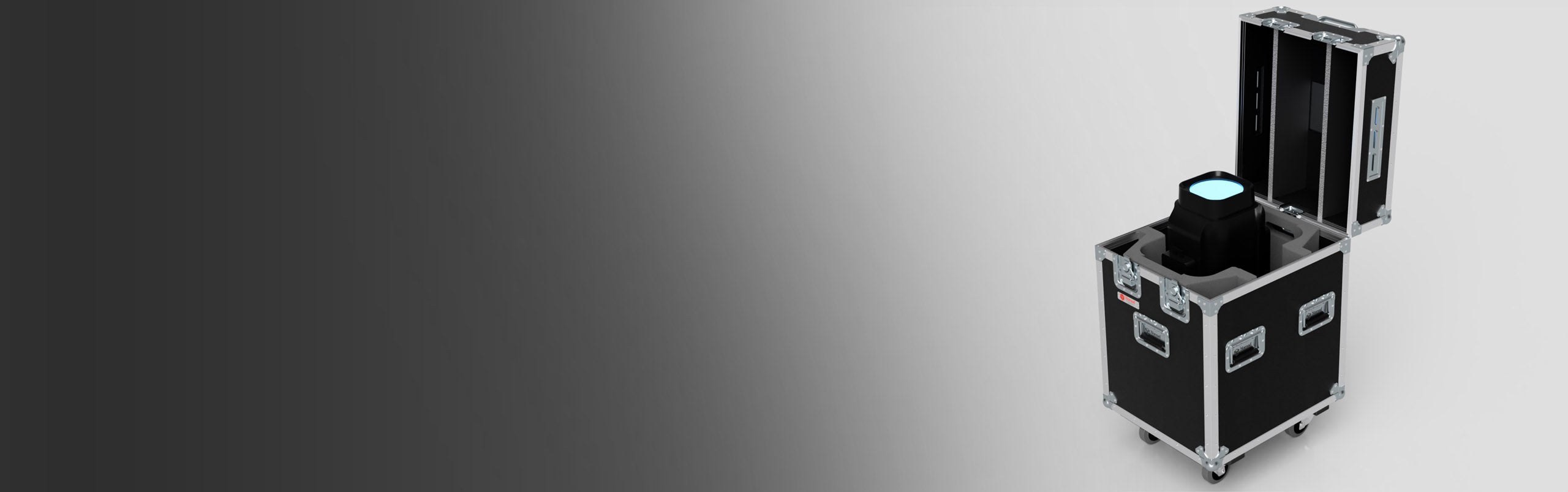 A black equipment case with metal edges is open, revealing a stage light inside; the background fades from dark gray on the left to light gray on the right.