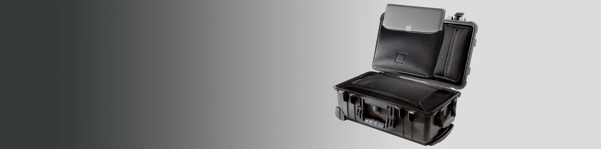 A black hard-shell suitcase is open, showing a laptop partially tucked into a padded compartment inside the lid.