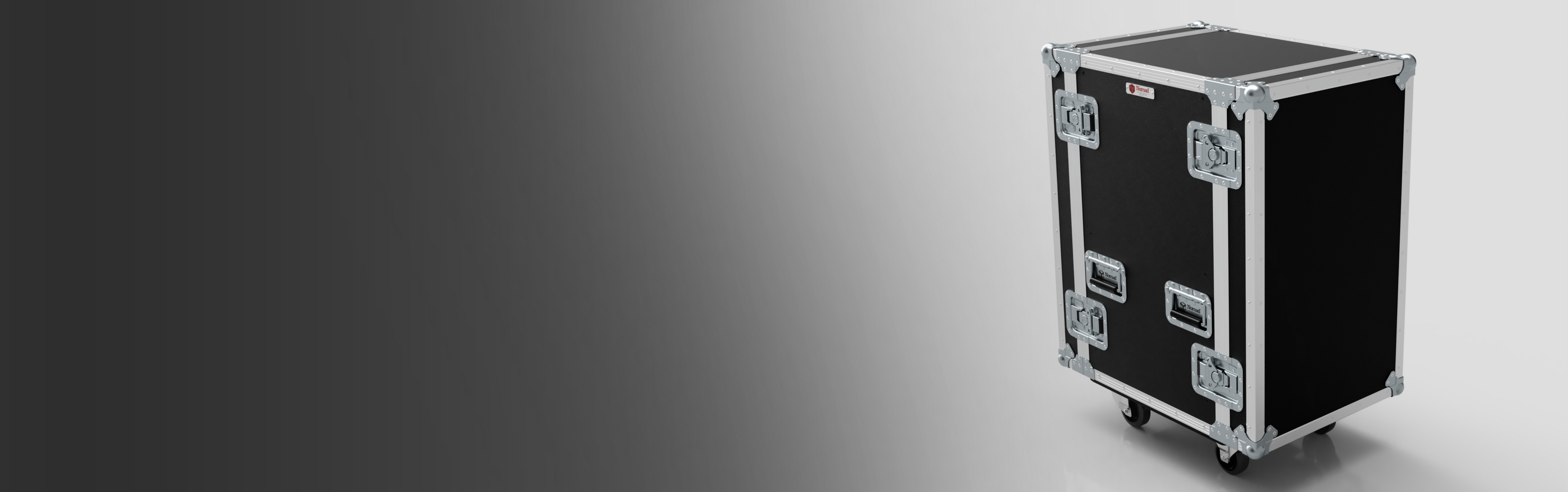 A black equipment flight case with metal edges, handles, and latches, stands on wheels against a gradient grey background.