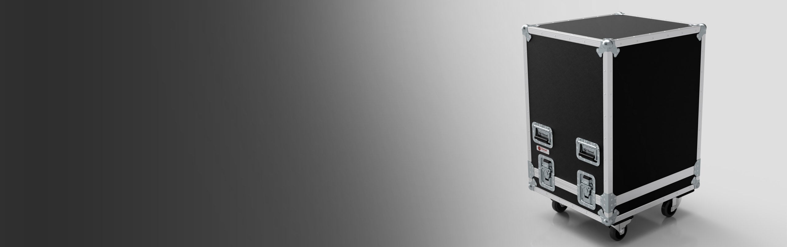 A black road case with metal edges and latches, equipped with wheels, positioned against a gray gradient background.