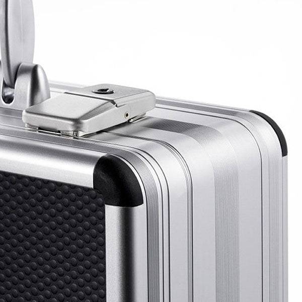 A close-up of the AZKE 95100's silver aluminum frame case shows its textured black panel, built-in combination lock, and precision CNC custom foam fittings inside.