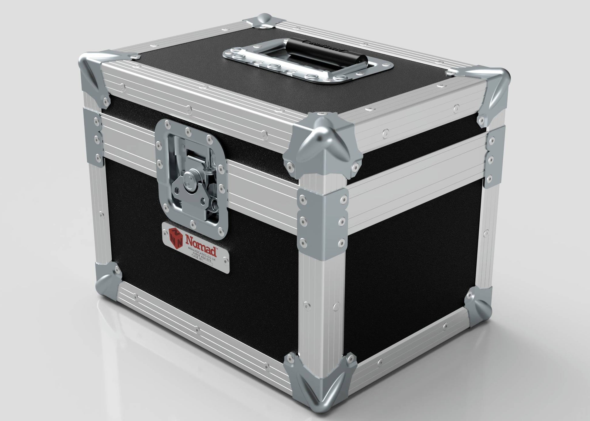 A black and silver Camera Lens Case with metal reinforcements, a top handle, front latch, and a Nomad label on the side.