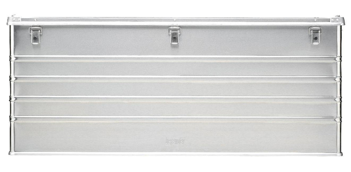 The Defender KA74-014 is a rectangular metal storage box with three top latch closures, horizontal ridges across the front, and a custom routed foam interior for secure organization.