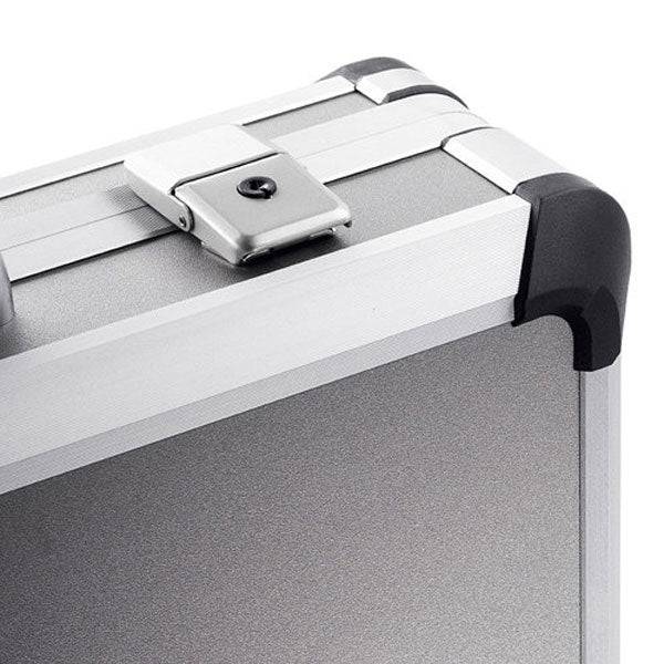 Close-up of the Exclusive 93400: a silver aluminium frame case with black corner protector, custom CNC foam fittings, and a sturdy metal latch.