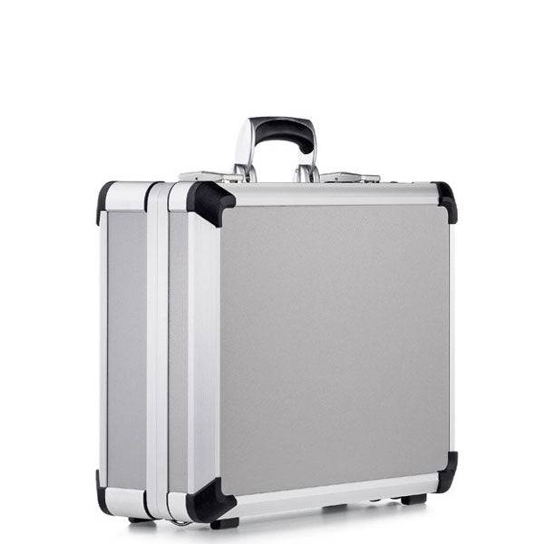 The Exclusive 93800 (445 x 340 x 150) is a premium silver hard-shell briefcase with black reinforced corners, a black handle, and an aluminium frame, shown standing upright on a white background.