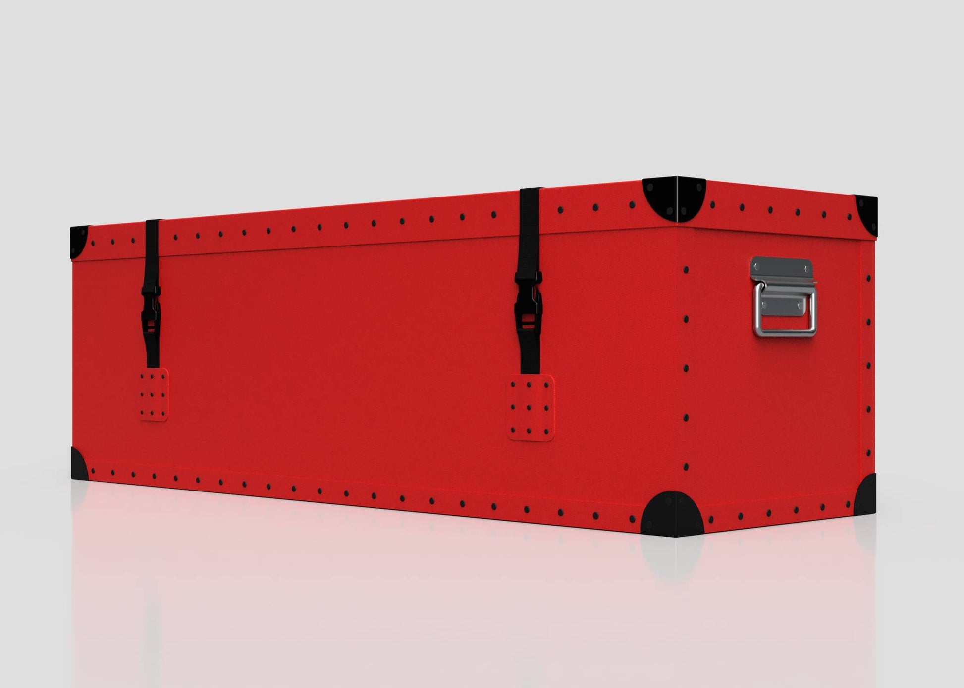 The Football Storage Poly Case (Medium) is a rectangular red trunk with black corner protectors, rivet details, two black webbing straps with side-release buckles, and a silver handle on one end, shown against a plain background.