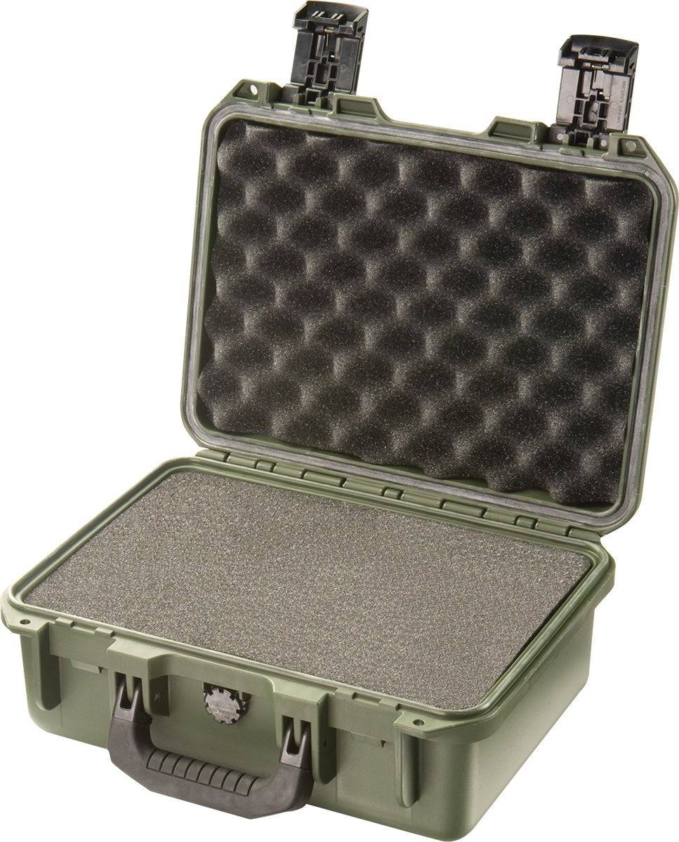 A green hard plastic iM2100 Storm Case with a black handle, shown open to reveal foam padding on the lid and base—this crushproof case offers rugged protection.