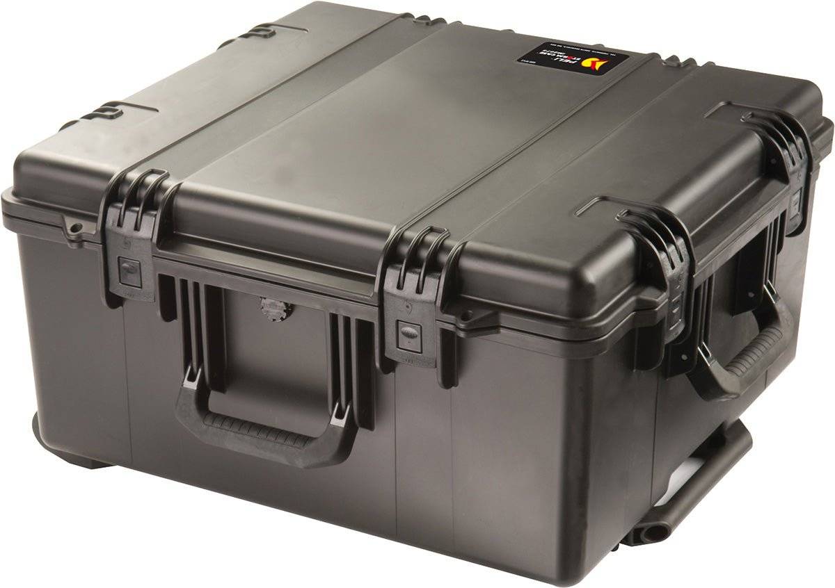 The iM2875 Storm Travel Case is a large, hard-shell black case with sturdy Press and Pull latches, side handles, custom CNC foam inserts, and a small top label.