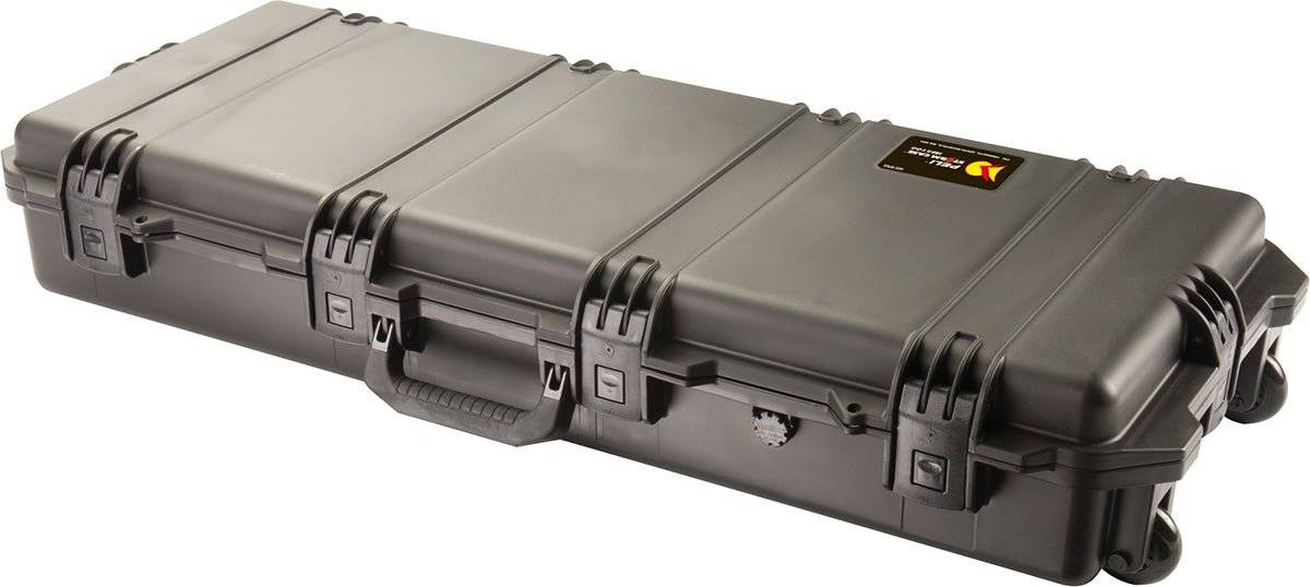 The iM3100 Storm Long Case is a large, hard-shell black case with custom CNC foam, a handle, wheels, a small top-right label, and Press & Pull latches for added protection.