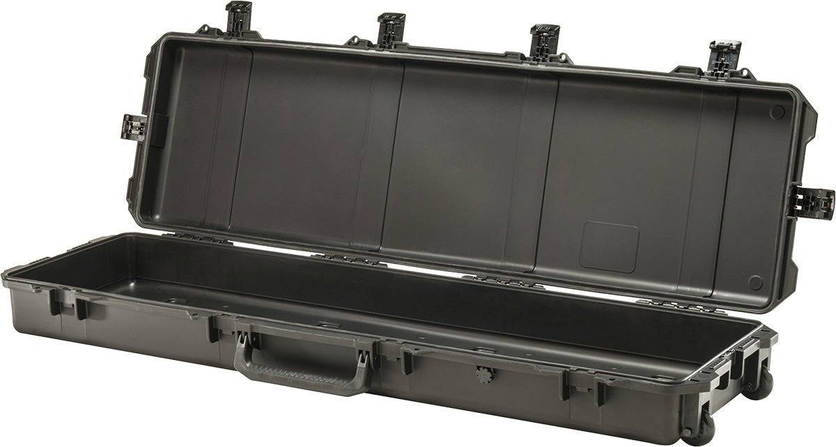 The open iM3300 Storm Long Case, a large black PELI case made of HPX Resin, features an empty interior, handle, wheels, and secure Press and Pull latches.