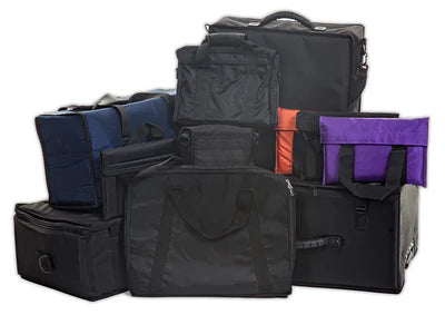 A group of various black, blue, orange, and purple carrying bags and cases arranged in a close cluster on a white background.