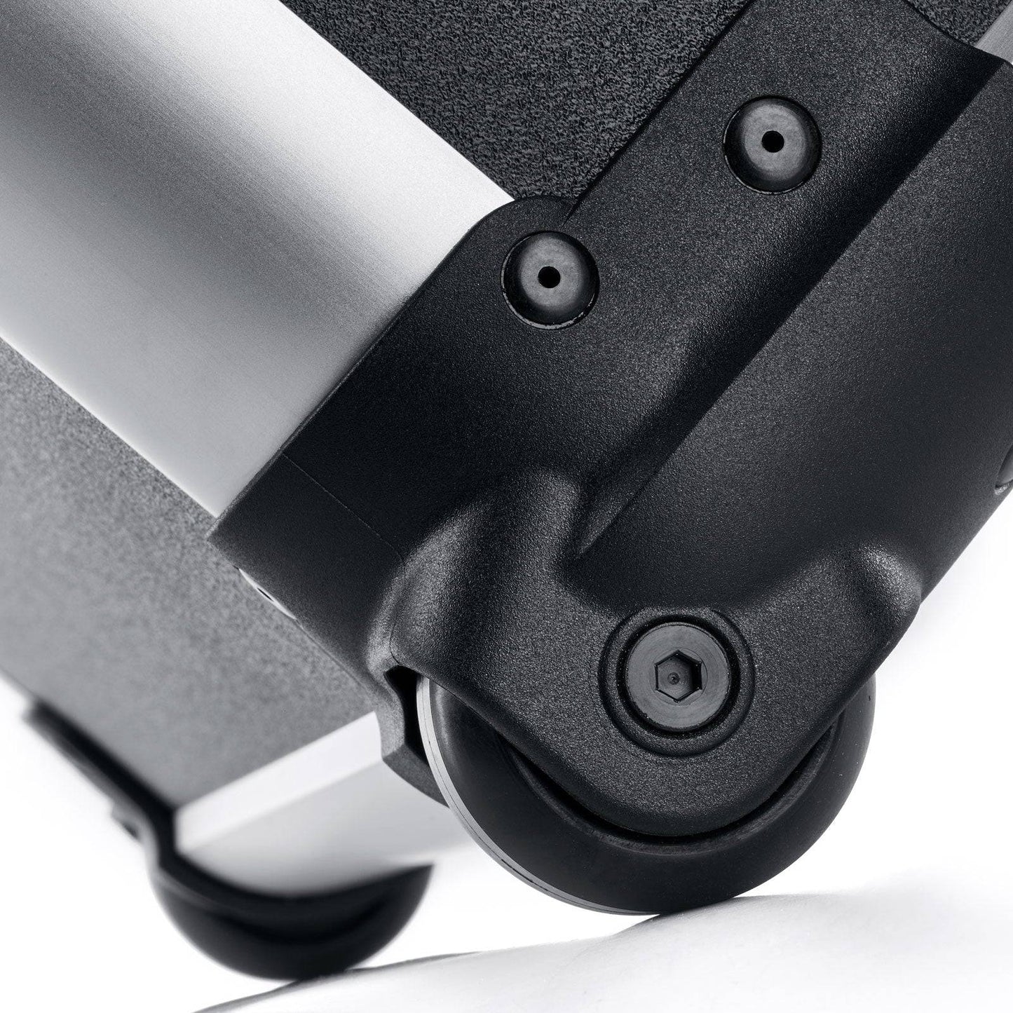Close-up of a black plastic caster wheel attached to the Robust 50200N (555 x 425 x 235) case, featuring a metal and textured surface—ideal for impact-resistant equipment protection.