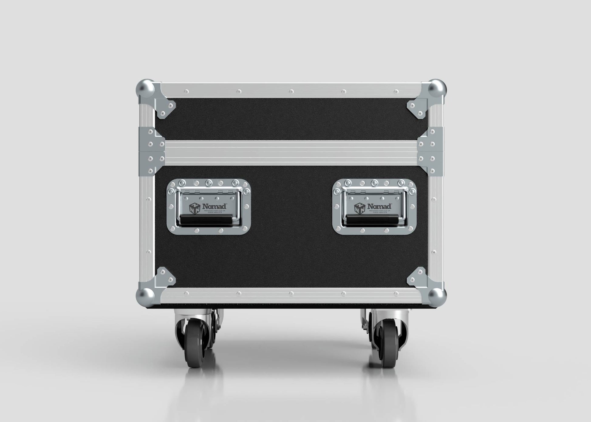 The Single 1 Ton EXE Motor Chain Hoist Case is a black and silver hard case with metal edges, two Nomad handles, and four caster wheels. Shown on a plain gray background. External dimensions: 696 x 607 x 580 mm.