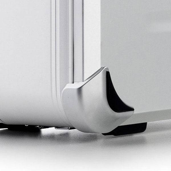 Close-up of the VDK 97100 silver aluminium case corner, showcasing its reinforced protective metal corner and part of the suitcase wheel.