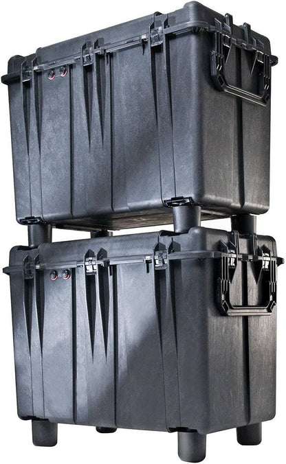 Two large black 0500 Protector Transport Cases with handles are stacked, with the top watertight case supported by raised feet on the bottom crushproof case.