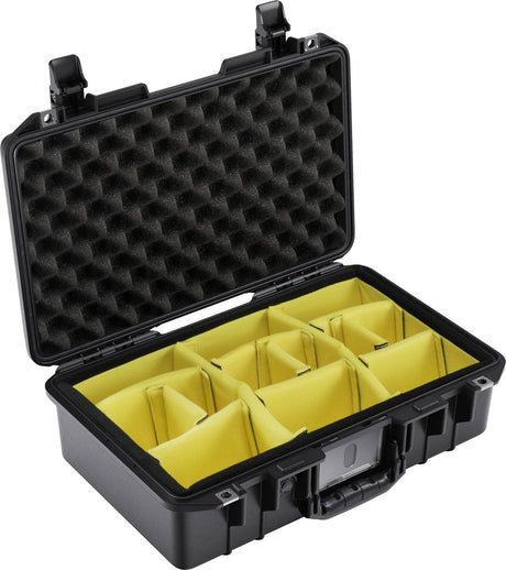 The 1485 Air Case is a lightweight black hard case with an open lid, featuring yellow padded dividers and foam lining for protective storage.