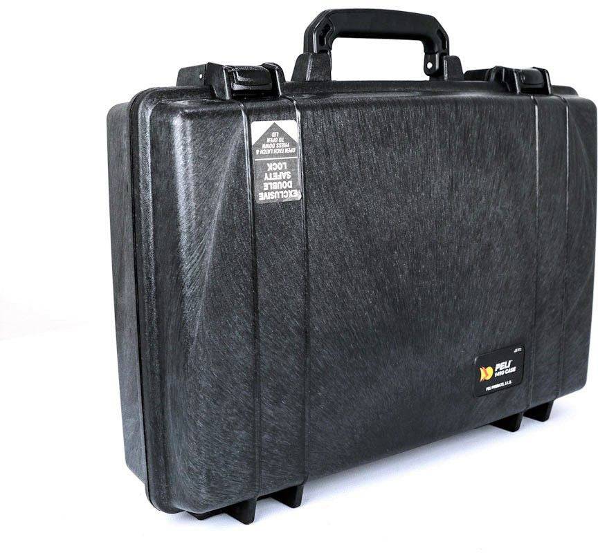 A hard-shell black PELI 1490 Protector Laptop Case with a handle, reinforced corners, and a small rectangular label stands on a white surface—a durable, rugged equipment case.
