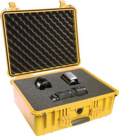 A yellow 1550EU Protector Case with foam inserts holds three camera lenses and a camera flash, all secured in custom-cut compartments.