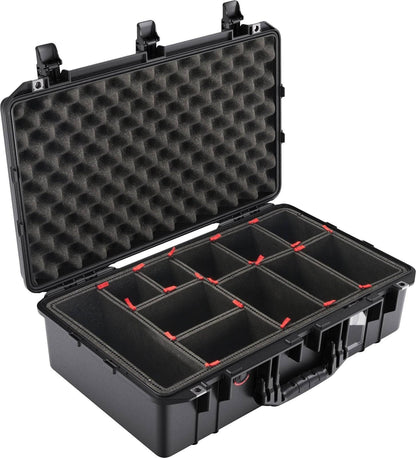 The 1555 Air Case is a hard plastic PELI carrying case with a foam-lined lid and adjustable padded compartments. It is open, displaying its dividers and interior storage sections, offering premium waterproof protection.