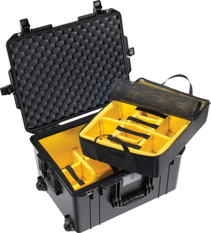 The black 1607 Air Case features yellow padded dividers, foam lid lining, a carry handle, mesh pocket, and a wheeled base. The protective waterproof case is open to reveal organized compartments inside.