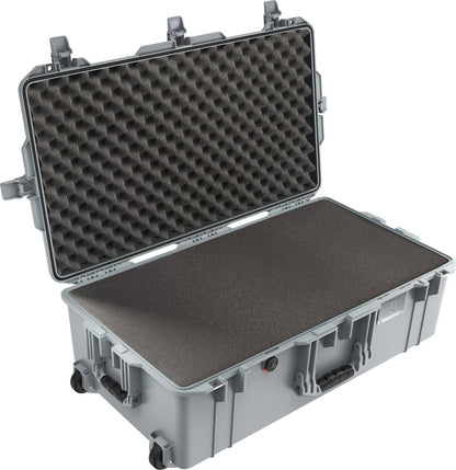 The 1615 Air Case is a large, hard-shell case with foam padding, shown open with egg-crate foam in the lid and flat foam in the base; includes transport handles and wheels.