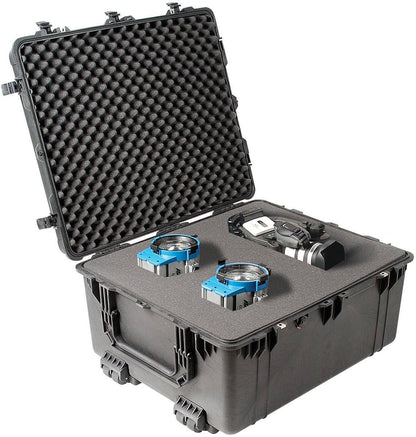 A crushproof 1690 Protector Transport Case with foam interior holds two blue electronic devices and a camera, its open lid revealing the contents.