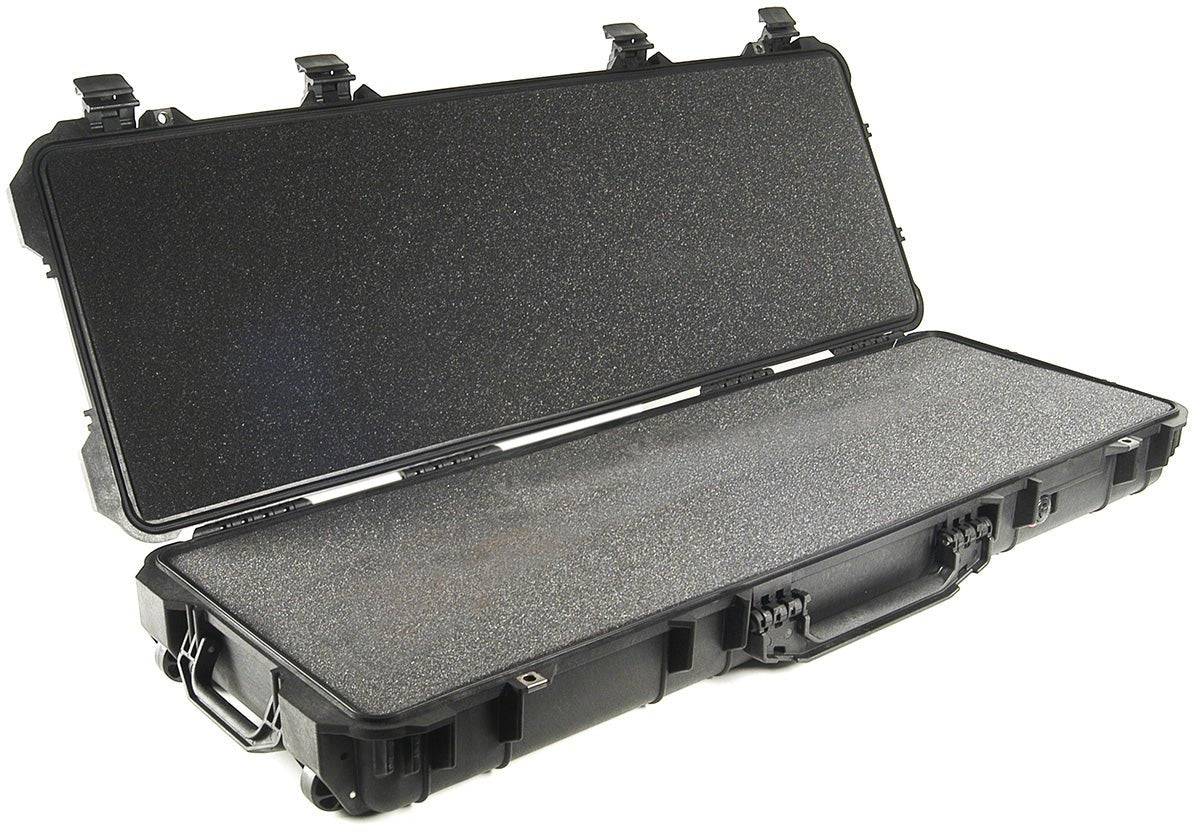 The 1720 Protector Long Case, a black hard-shell PELI case with textured foam interior, is open to show its inside compartment and sturdy latches.