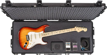 The 1745 Air Case securely holds an electric guitar, three effects pedals, a coiled cable, and a power supply with foam padding in a lightweight polymer shell for reliable protection.