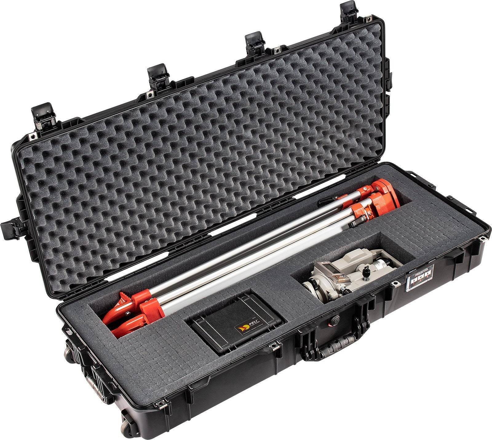 A 1745 Air Case with custom foam protects red and silver industrial equipment, a controller, and accessories, offering durable waterproof storage for all contents.