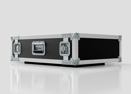 The 2U Suspended Shock Mounted Rack Case, a large rectangular black and silver case with metal-reinforced corners and latches, sits on a reflective white surface and provides superior protection with its shock mounted rack.