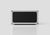 The 4U Suspended Shock Mounted Rack Case, a rectangular black case with metal edges and corner protectors and anti-vibration mounts, rests on a reflective white surface against a plain light background.