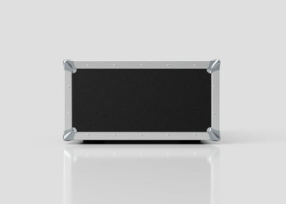The 4U Suspended Shock Mounted Rack Case, a rectangular black case with metal edges and corner protectors and anti-vibration mounts, rests on a reflective white surface against a plain light background.