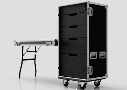 A 5 Drawer Production Case in black, featuring silver hardware and measuring 644x616x1325mm, stands beside an external trestle table with metal legs against a plain background.