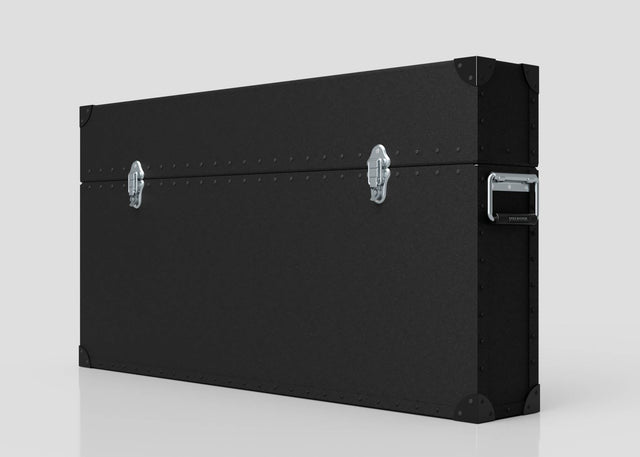 The 65" Single Screen Lite Guard™ Case is a large, black HDPE transport case with metal corner protectors, two silver latches, and a side handle, designed for secure display transport. Shown against a plain light background.
