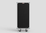 The Nomad Cases 7 Drawer Production Case is a black rectangular equipment case with metal edges, corner protectors, and side hardware, standing upright on four caster wheels. Compact and practical, it is shown against a plain light gray background.
