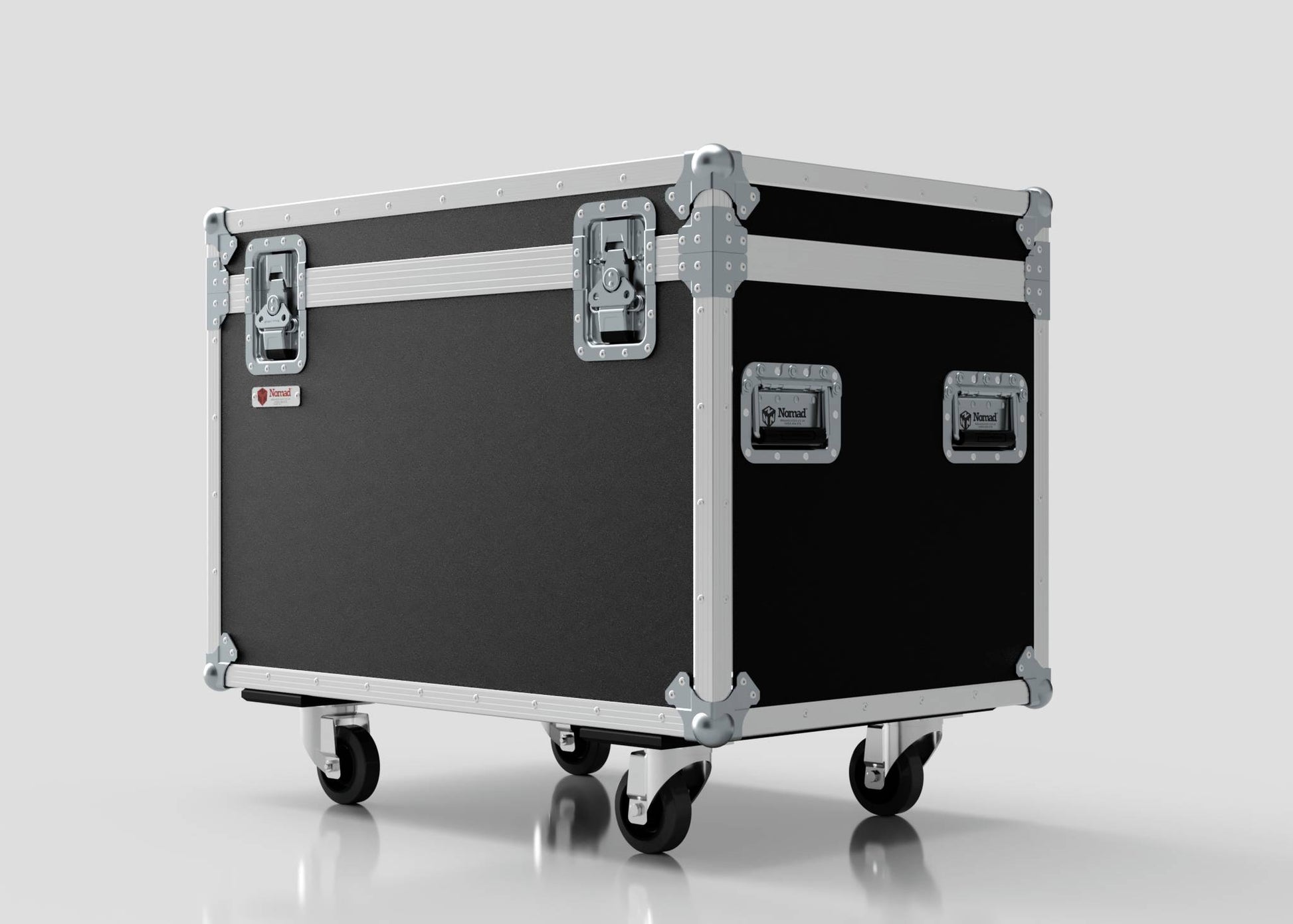The 900mm Trunk Case is a large black and silver equipment case with metal reinforcements, handles, and four caster wheels. It stands against a plain light background and has external dimensions of 925 x 607 x 765 mm.