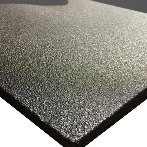 Close-up of a textured, black, rectangular foam sheet with a slightly reflective surface.