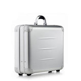 The ALUpur 98300, a silver anodised aluminium case with a curved handle and sturdy metal hinges, stands upright on a white background.