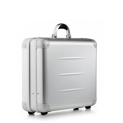 The ALUpur 98300, a silver anodised aluminium case with rounded edges, metal hinges, and a metallic handle, stands upright against a plain white background.