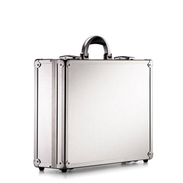 The ARK 90100 is a sturdy silver metal briefcase with reinforced corners, a black handle, and an aluminium frame, shown standing upright against a plain white background.