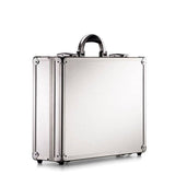 The ARK 90100 is a sturdy silver metal briefcase with reinforced corners, a black handle, and an aluminium frame, shown standing upright against a plain white background.