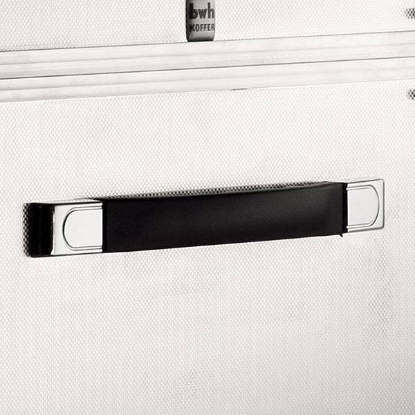 A close-up of a black and silver handle mounted on a textured, light surface, likely the ARK 90900 aluminium frame case with custom CNC foam fittings for added protection.